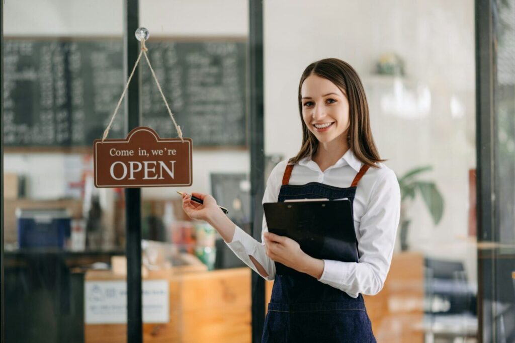 Startup successful small business owner sme woman stand with tablet in cafe restaurant.